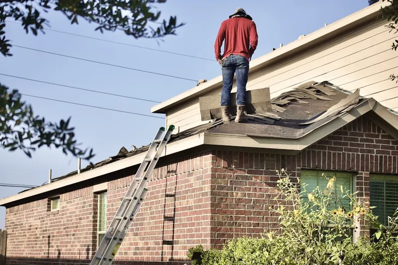 Professional roofer working on a residential roof in Larkin